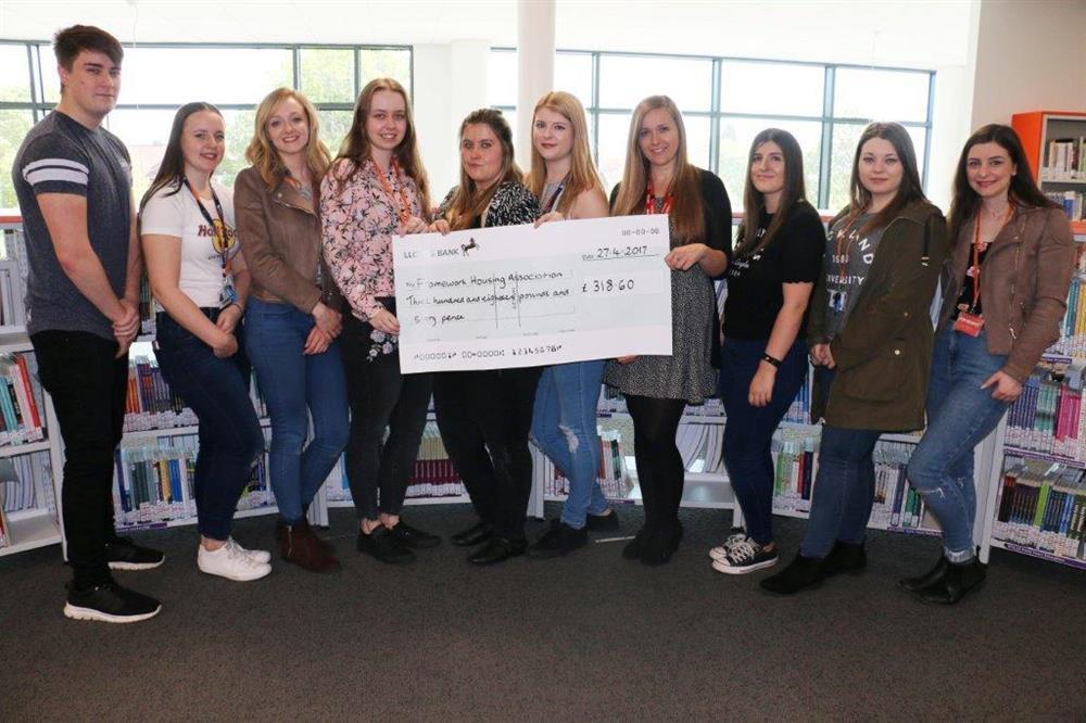 Proud students presented Framework's Abbi Mayfield (4th right) with their generous cheque