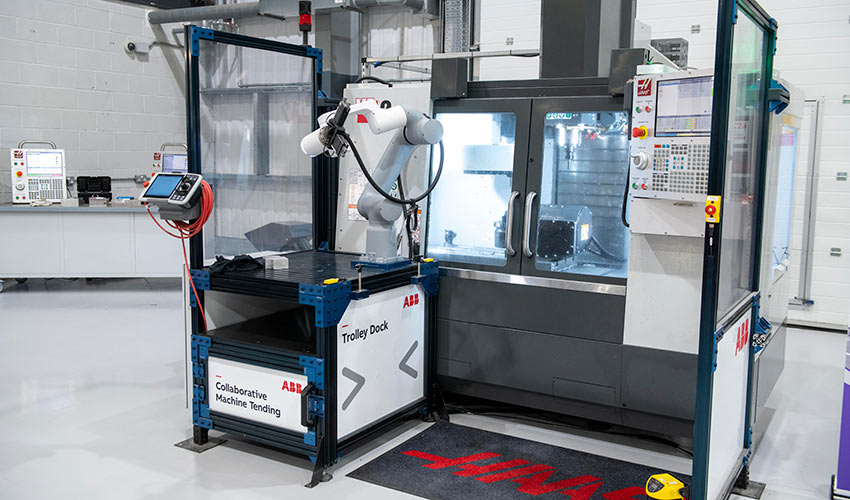 A collaborative robot (cobot) working alongside a CNC machine.