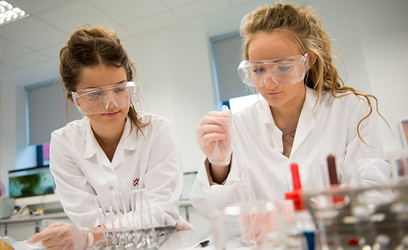 Image of two young women in a science lab