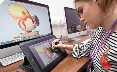 Image of a young female student using a tablet to design artwork.