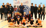 Image of pupils from Greenwood Primary with sports students and Goalball UK's Stephen Newey.