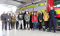 Image of a group of students stood in front of a fire engine.