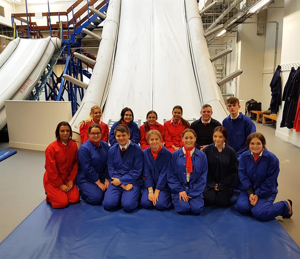 Travel and tourism students used the emergency slide during their training at Heathrow Airport